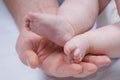 Little baby feets in dads hand